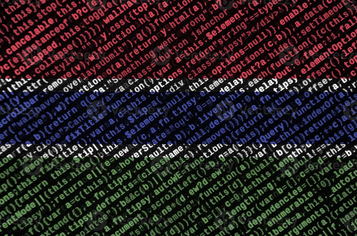 Gambia flag is depicted on the screen with the program code. The concept of modern technology and site development photo