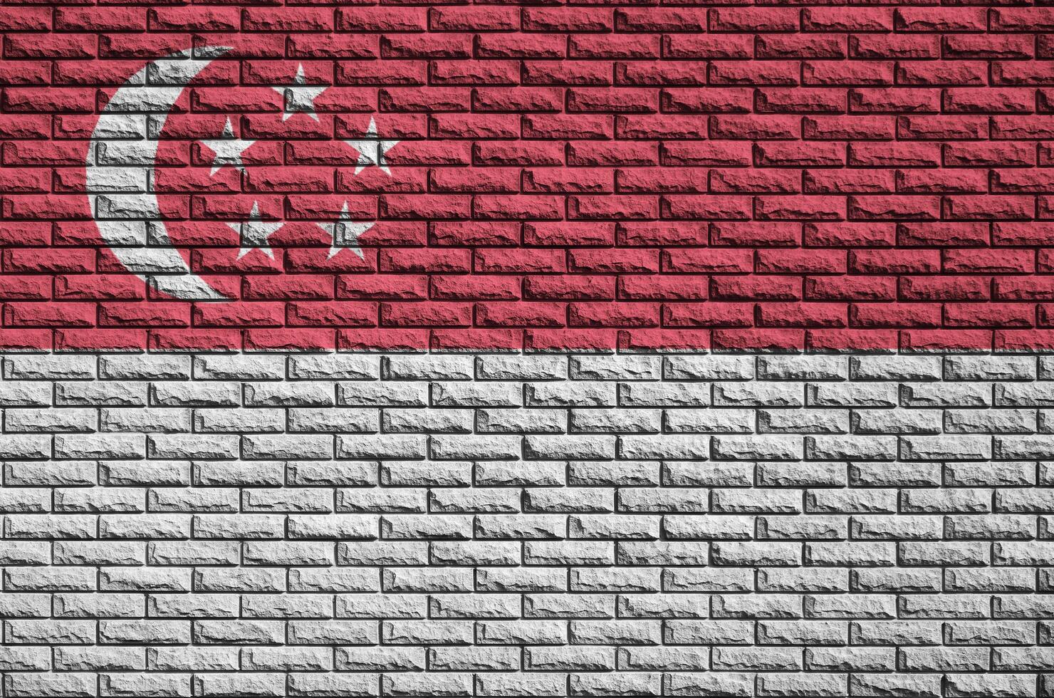 Singapore flag is painted onto an old brick wall photo