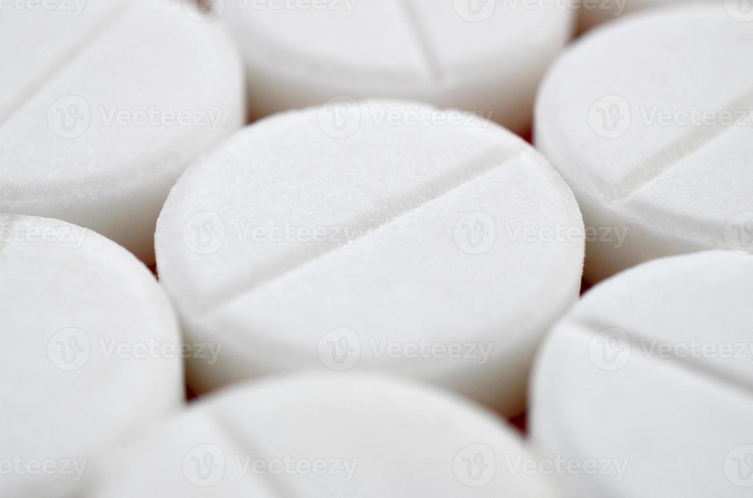 Close-up image of white pills. Macro with extremely shallow depth of field photo