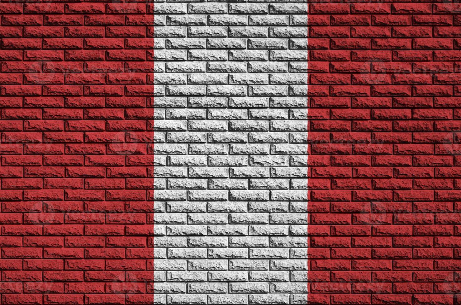 Peru flag is painted onto an old brick wall photo