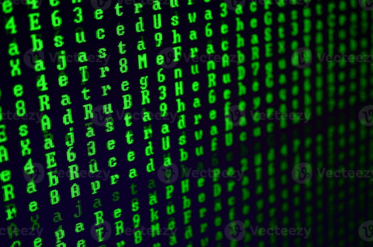 Macro shot of a glitch on the monitor of an office computer. The concept of introducing a virus into a personal data keeper. Stream of random green symbols on a black background photo
