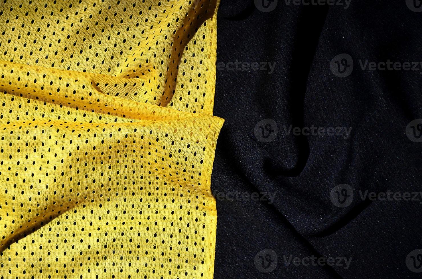 Sport clothing fabric texture background. Top view of yellow polyester nylon cloth textile surface. Colored basketball shirt with free space for text photo