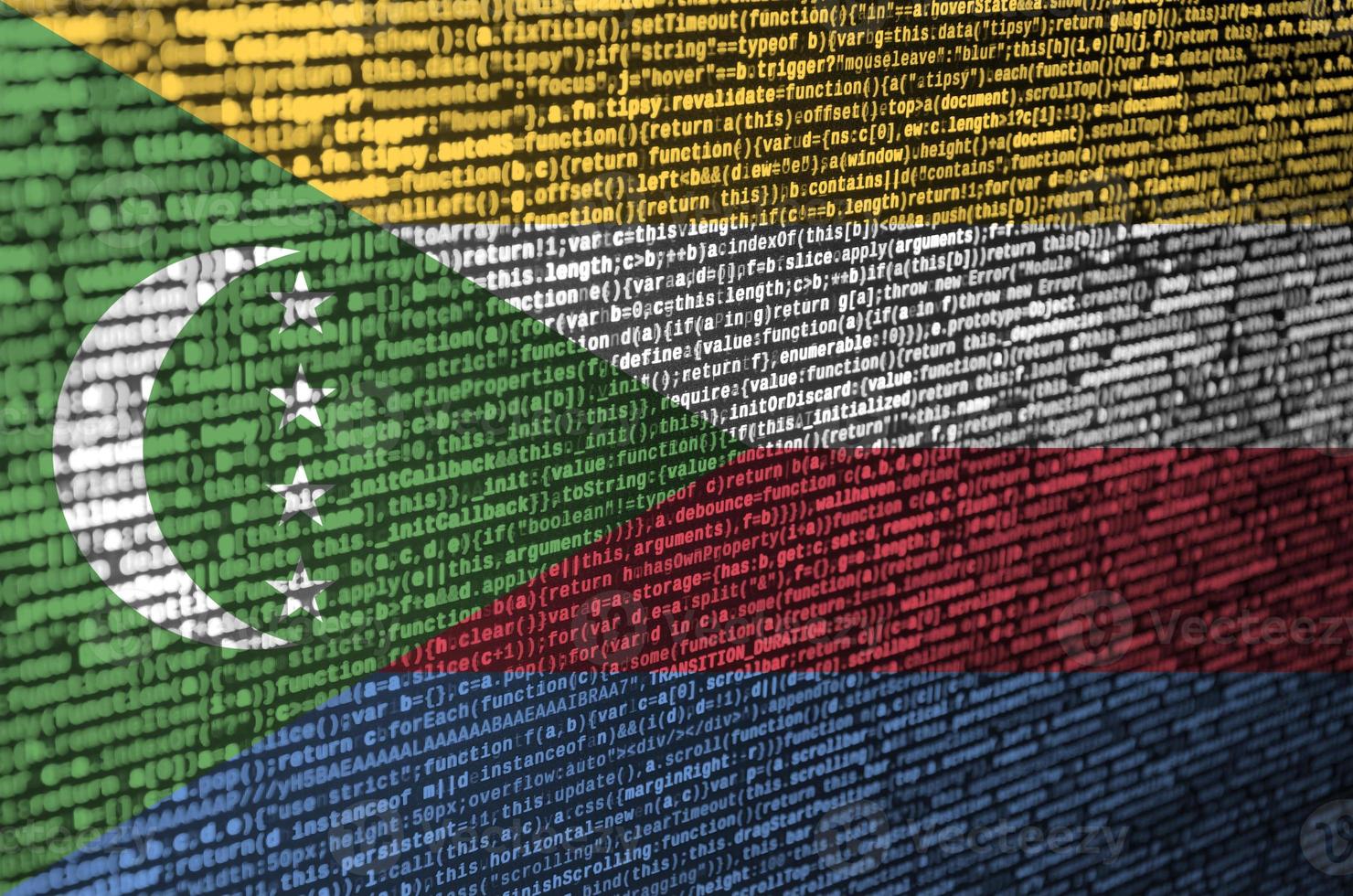 Comoros flag is depicted on the screen with the program code. The concept of modern technology and site development photo