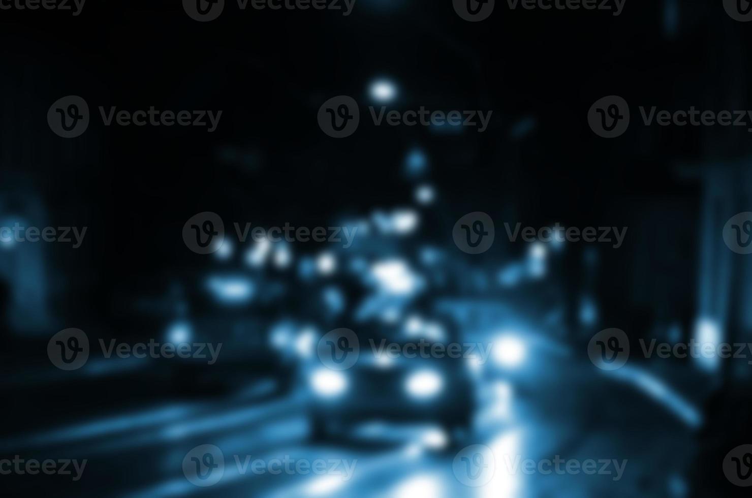 Blurred night scene of traffic on the roadway. Defocused image of cars traveling with luminous headlights. Bokeh Art photo