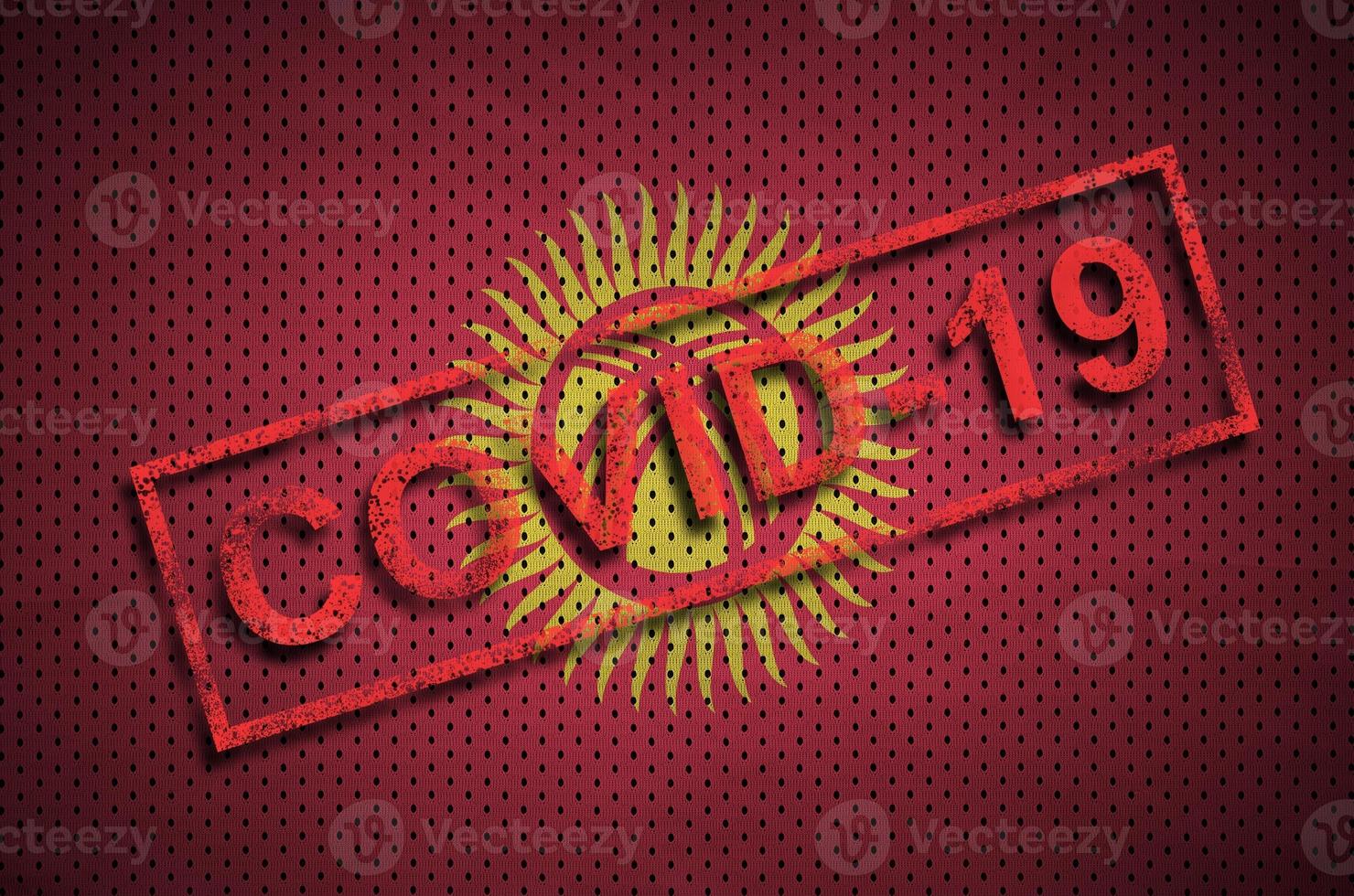 Kyrgyzstan flag and red Covid-19 stamp. Coronavirus 2019-nCov outbreak photo