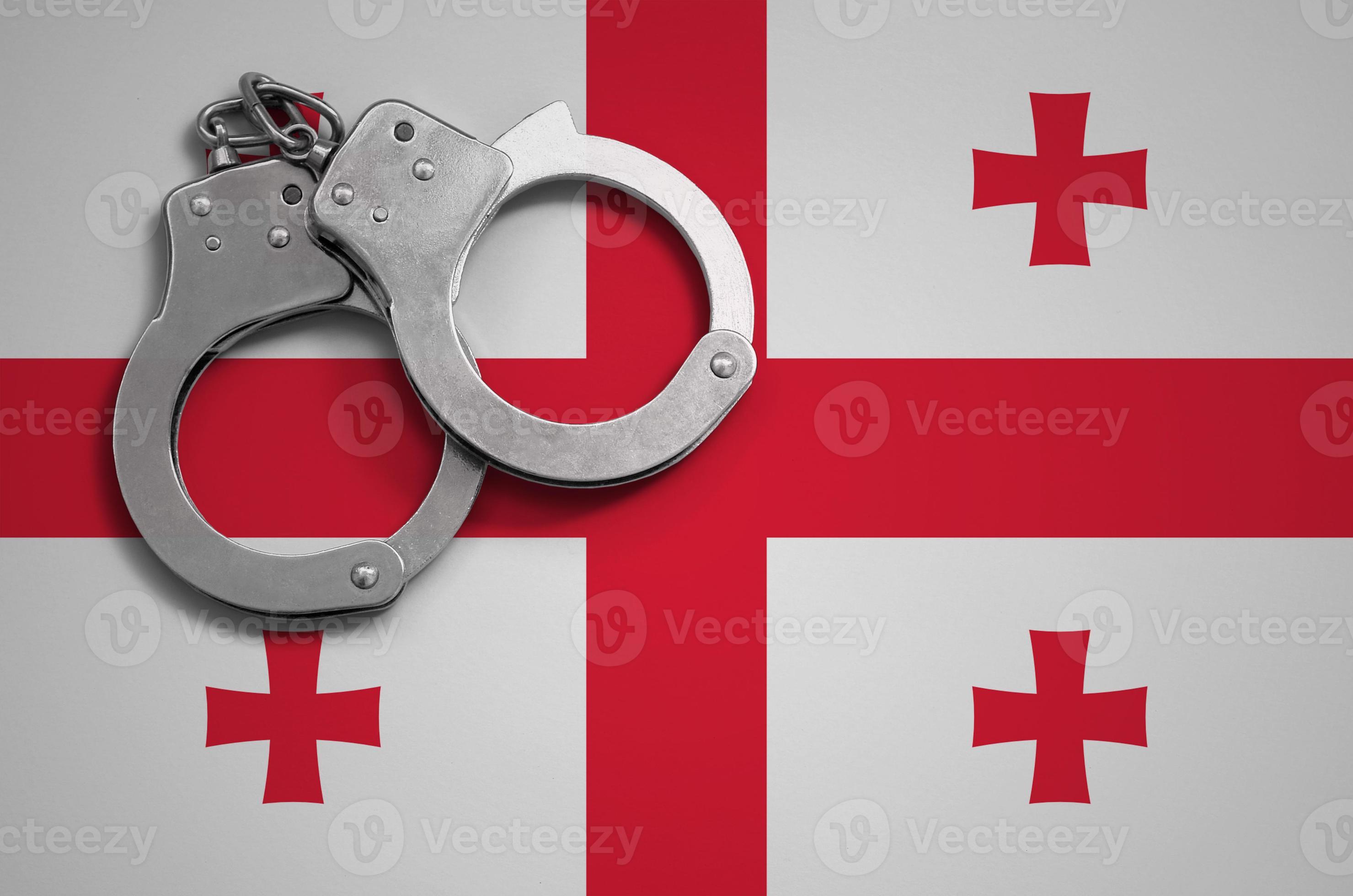 flag and police handcuffs. The concept of crime and offenses in