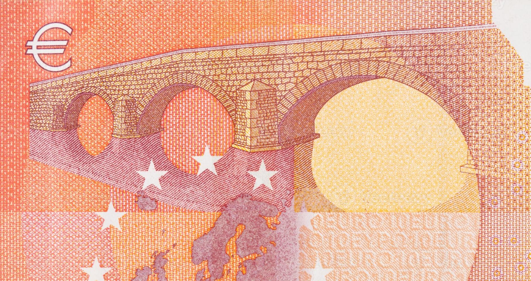 Fragment part of 10 euro banknote close-up with small red details photo