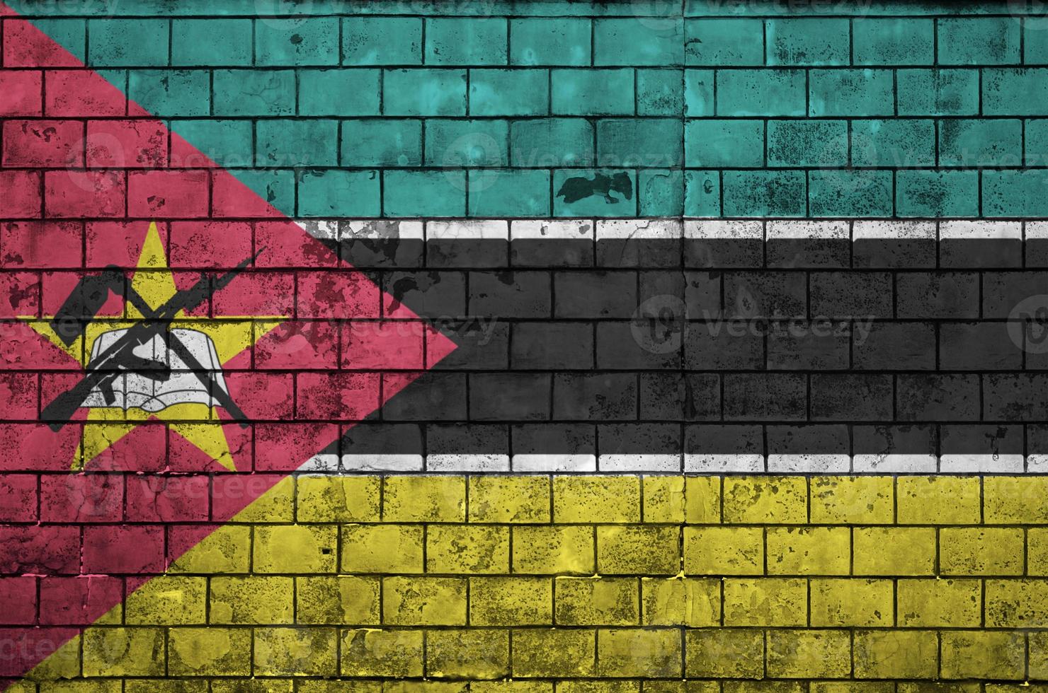 Mozambique flag is painted onto an old brick wall photo