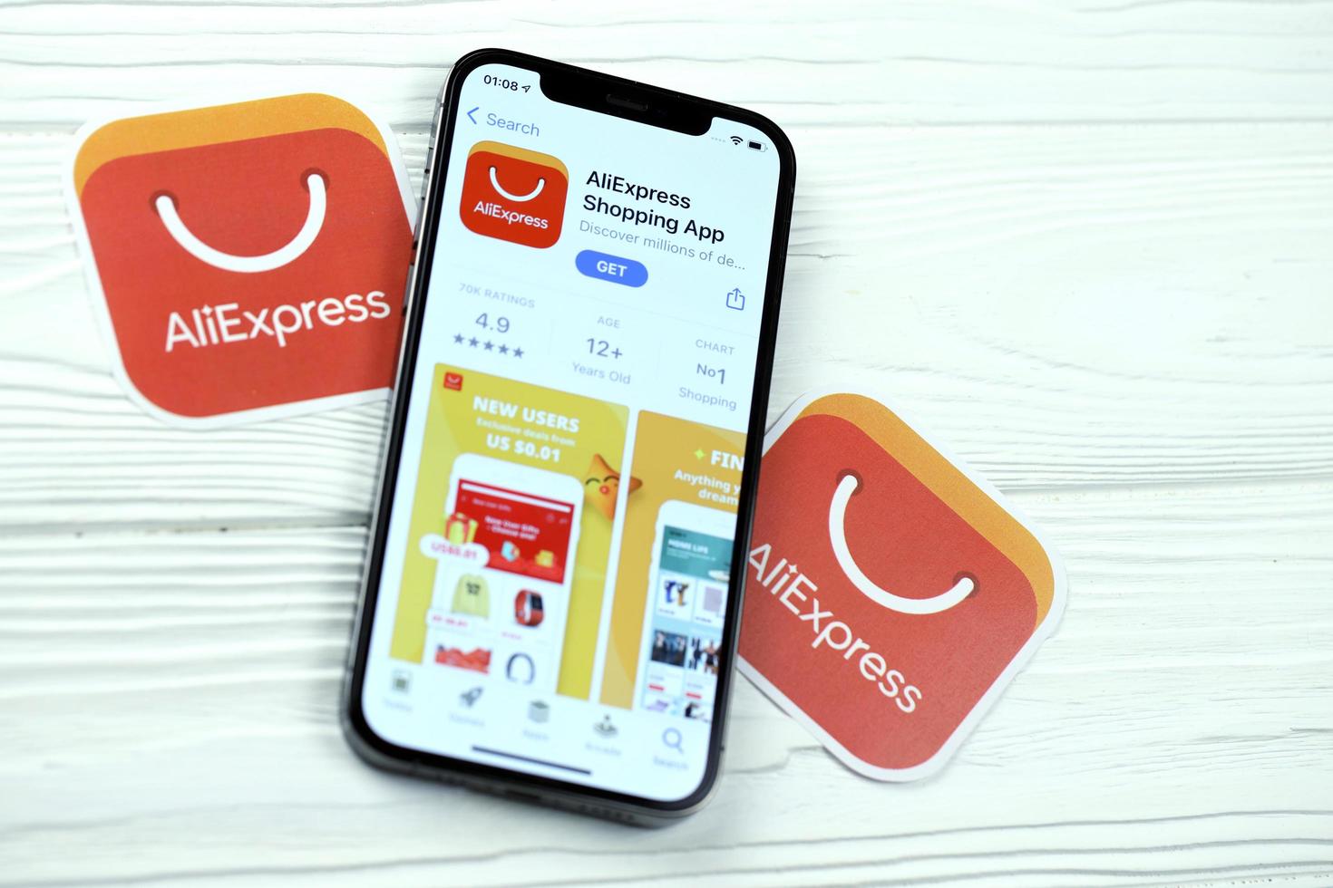 KHARKOV, UKRAINE - MARCH 5, 2021 Aliexpress icon and application from App store on iPhone 12 pro display screen on white table photo