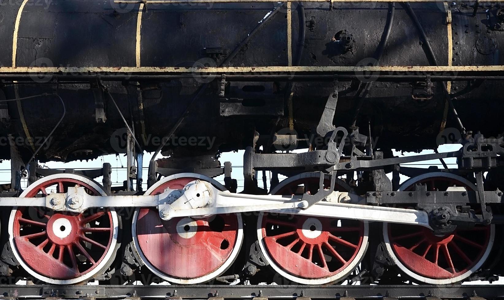 Red wheels of steam train photo