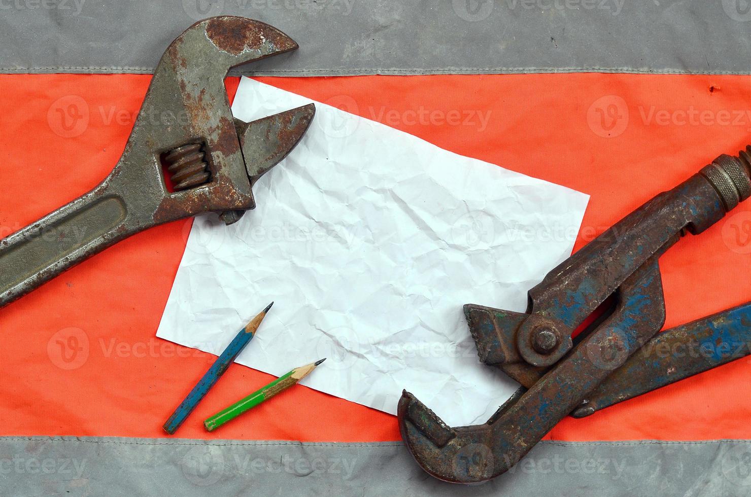 Adjustable wrenches and a sheet of paper with two pencils photo