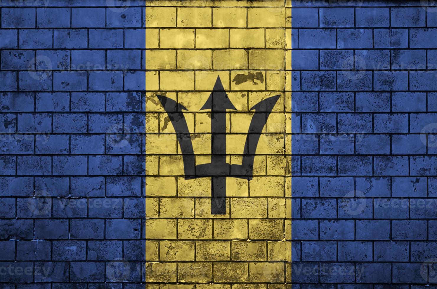 Barbados flag is painted onto an old brick wall photo