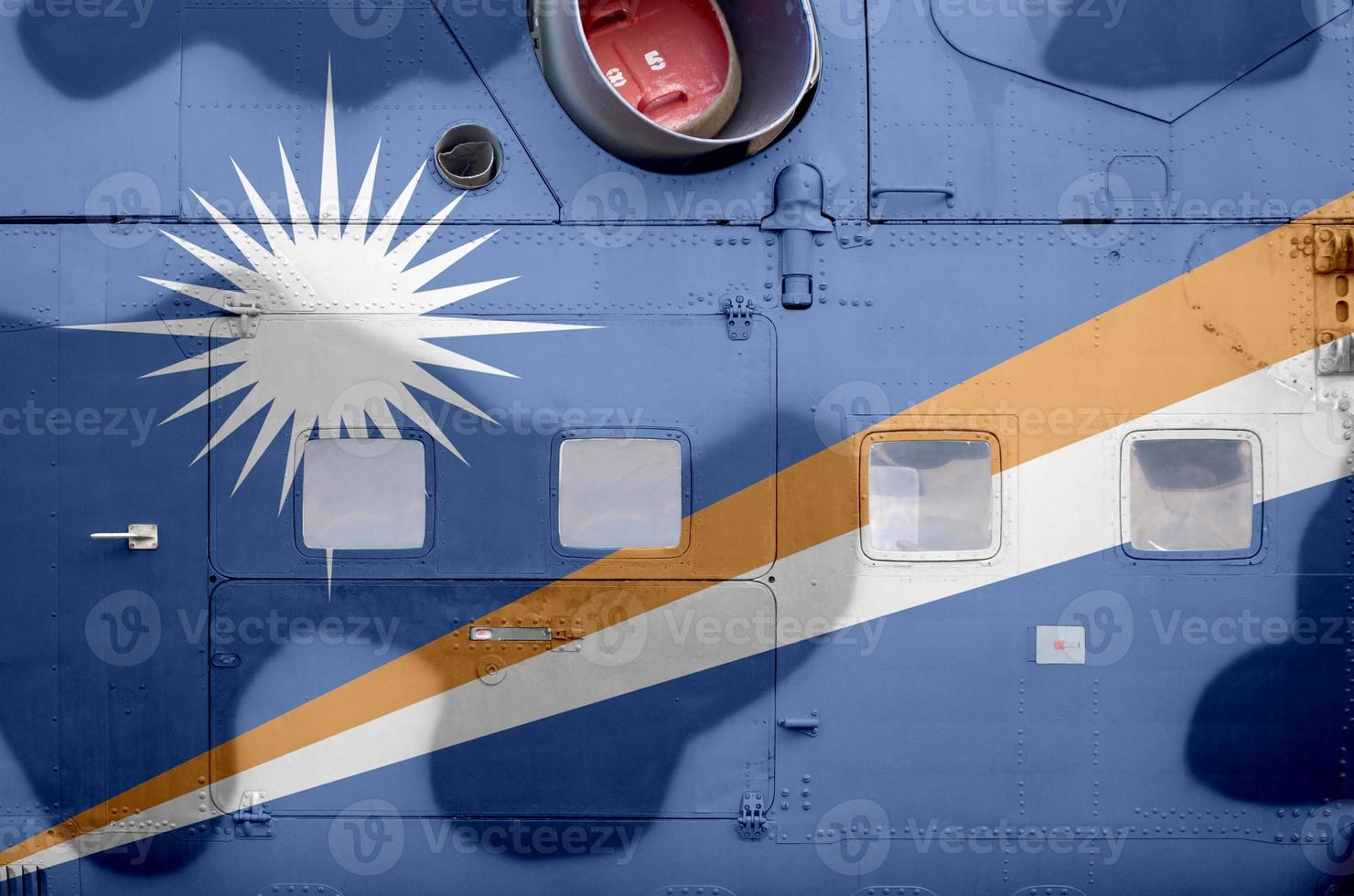 Marshall Islands flag depicted on side part of military armored helicopter closeup. Army forces aircraft conceptual background photo