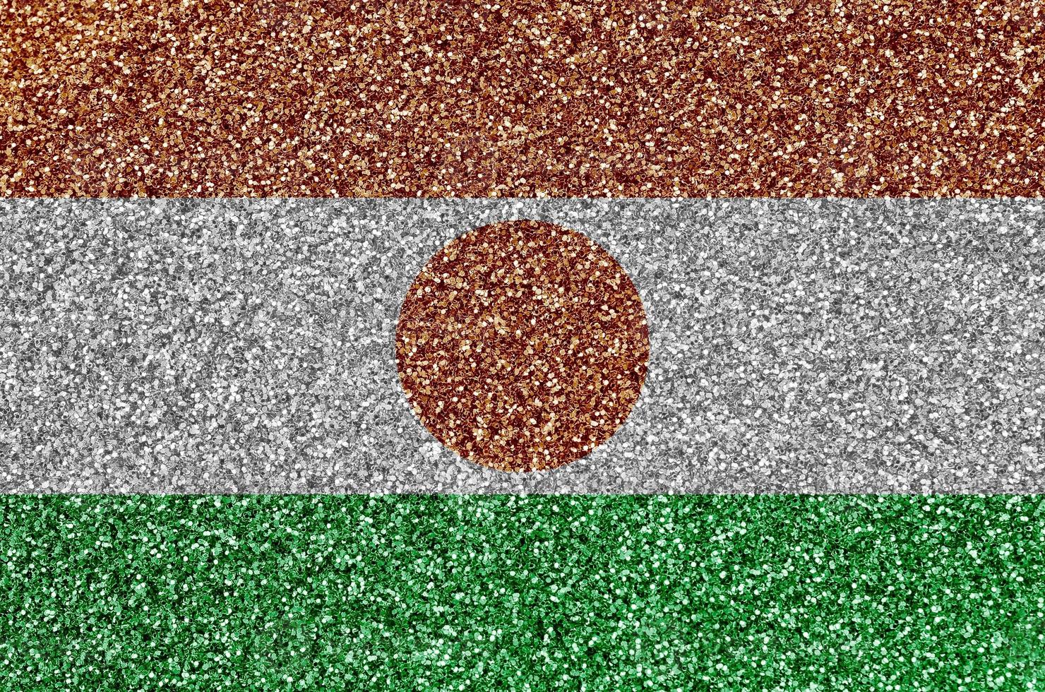 Niger flag depicted on many small shiny sequins. Colorful festival background for party photo