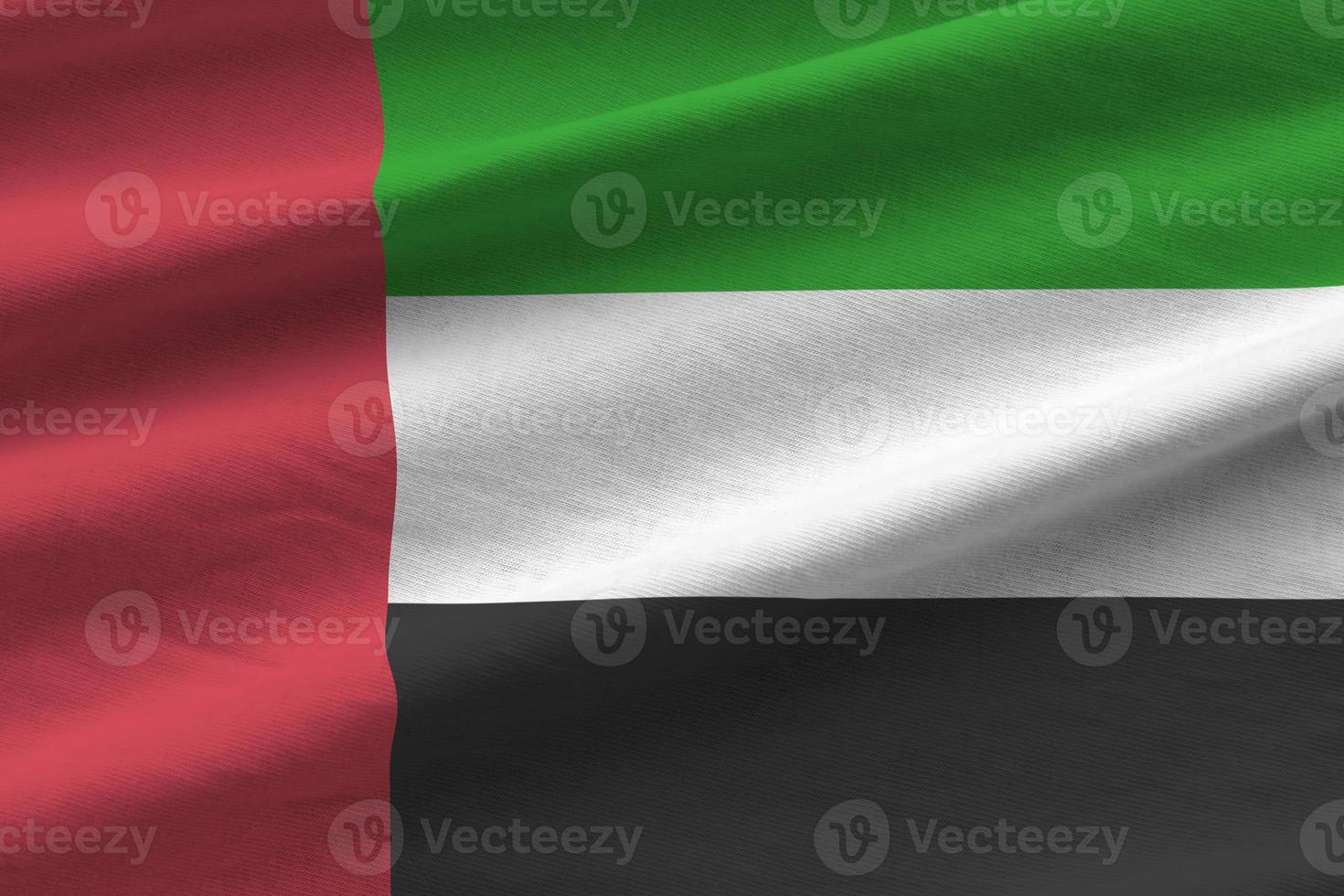United Arab Emirates flag with big folds waving close up under the studio light indoors. The official symbols and colors in banner photo