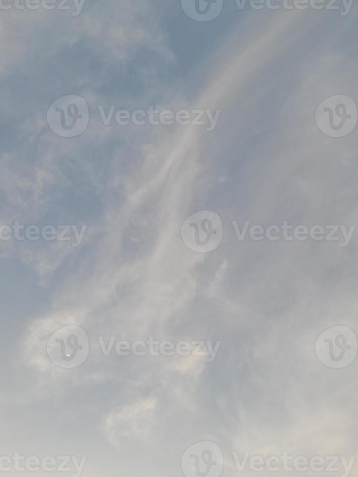 The view of the sky before sunset with the moon in sight photo