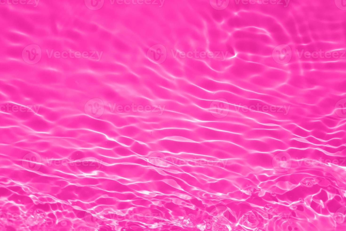 Defocus blurred transparent purple colored clear calm water surface texture with splash, bubble. Shining purple water ripple background. Surface of water in swimming pool. Purple bubble water shine. photo