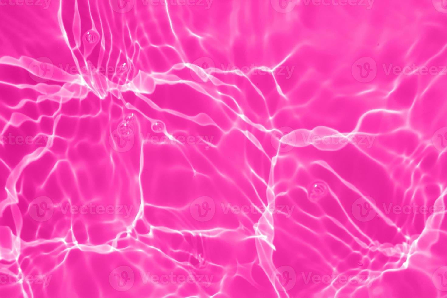 Defocus blurred transparent purple colored clear calm water surface texture with splash, bubble. Shining purple water ripple background. Surface of water in swimming pool. Purple bubble water shine. photo