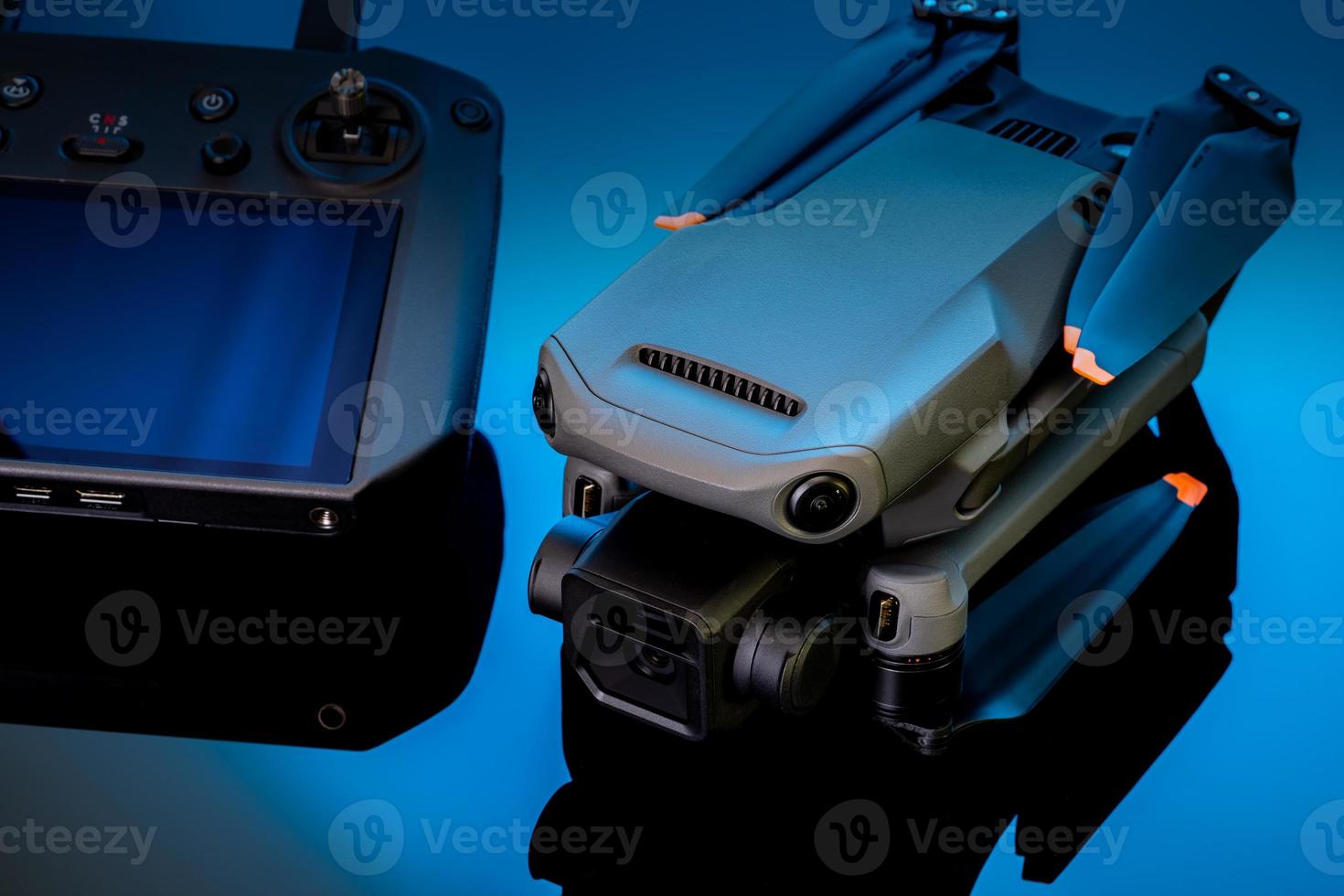 Drone and remote controller. UAV or unmanned aerial vehicle. Quadcopter drone aircraft with a digital camera. Modern remote control aerial drone with a camera for taking aerial photography or video. photo