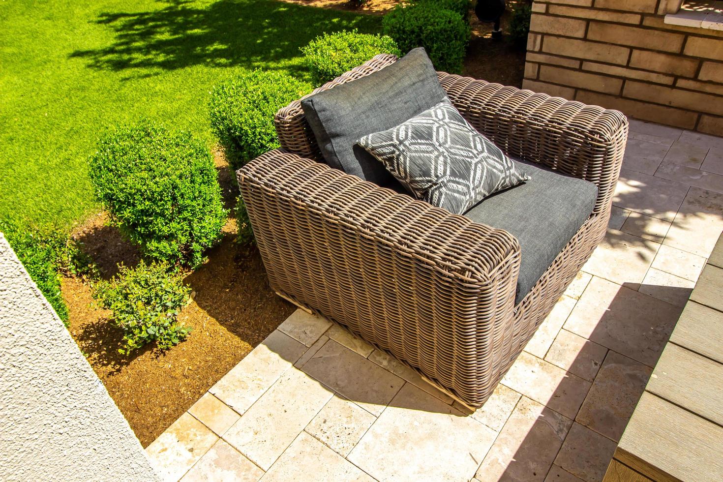 Large Wicker Arm Chair On Back Yard Patio photo