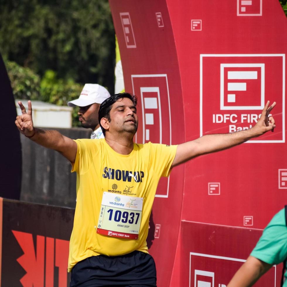 New Delhi, India - October 16 2022 - Vedanta Delhi Half Marathon race after covid in which marathon participants about to cross the finish line, Delhi Half Marathon 2022 photo