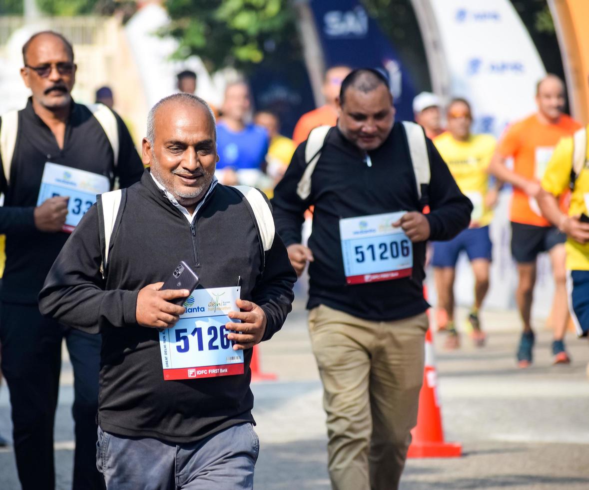 New Delhi, India - October 16 2022 - Vedanta Delhi Half Marathon race after covid in which marathon participants about to cross the finish line, Delhi Half Marathon 2022 photo