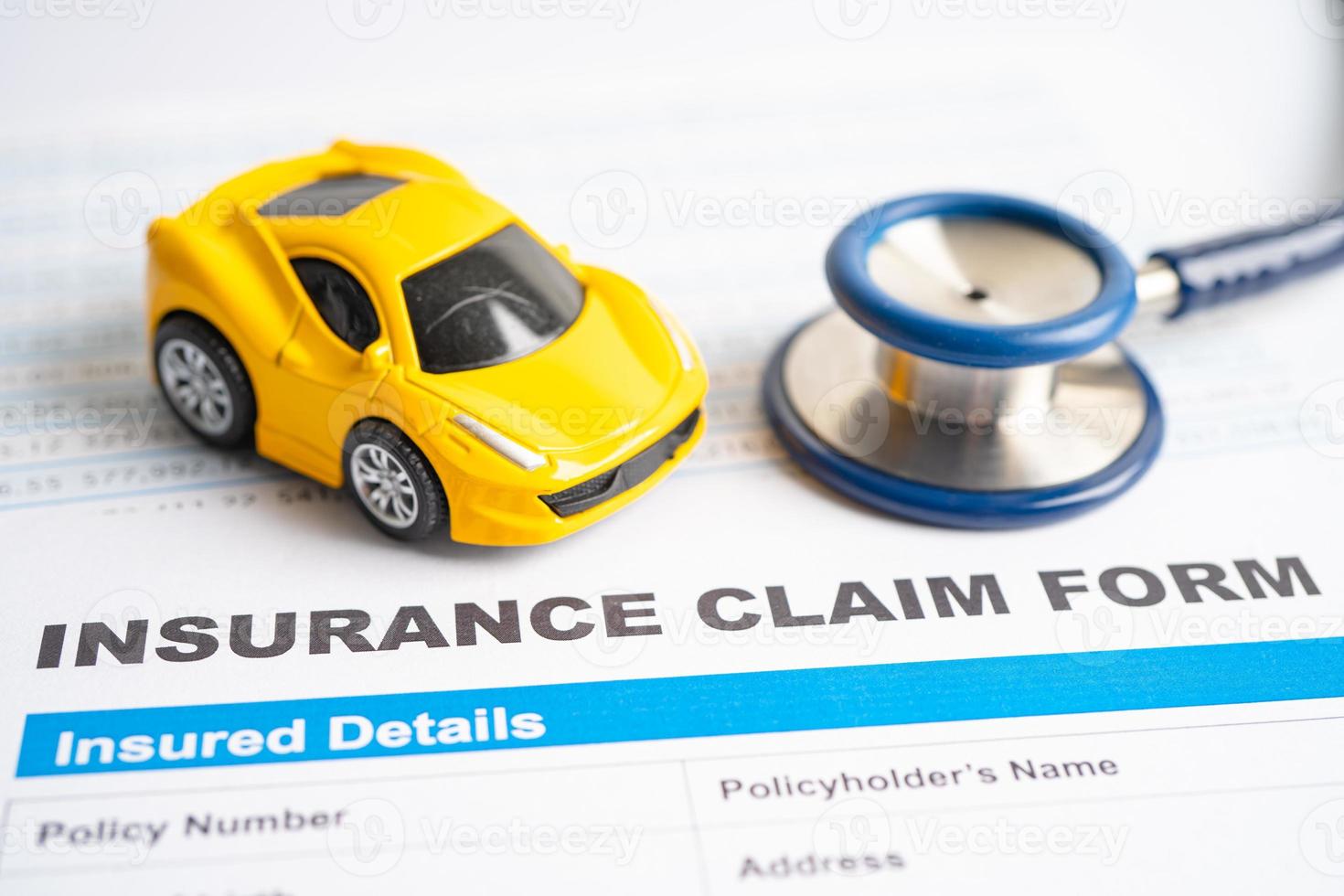 Stethoscope on Insurance claim accident car form, Car loan, insurance and leasing time concepts. photo