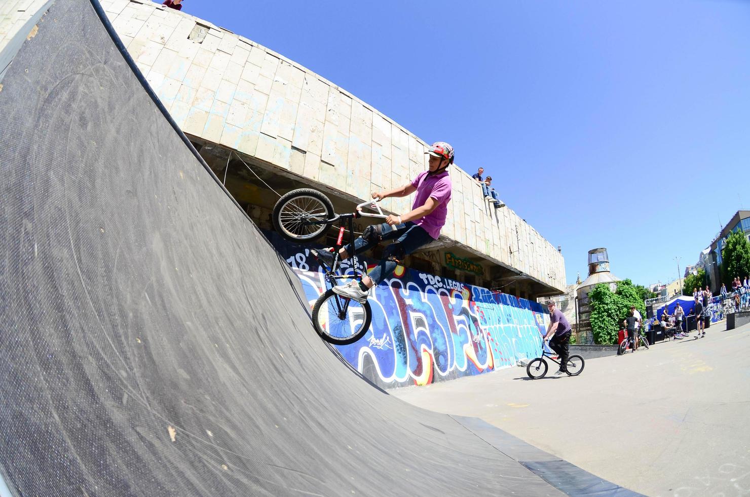 KHARKIV, UKRAINE - 27 MAY, 2018 Freestyle BMX riders in a skatepark during the annual festival of street cultures photo