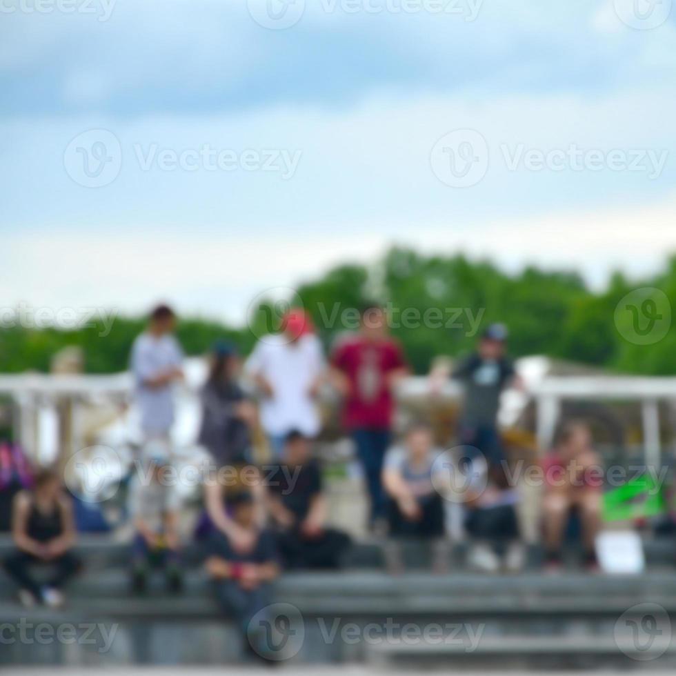 Defocused image of a lot of people with bmx bikes. Meeting of fans of extreme sports photo