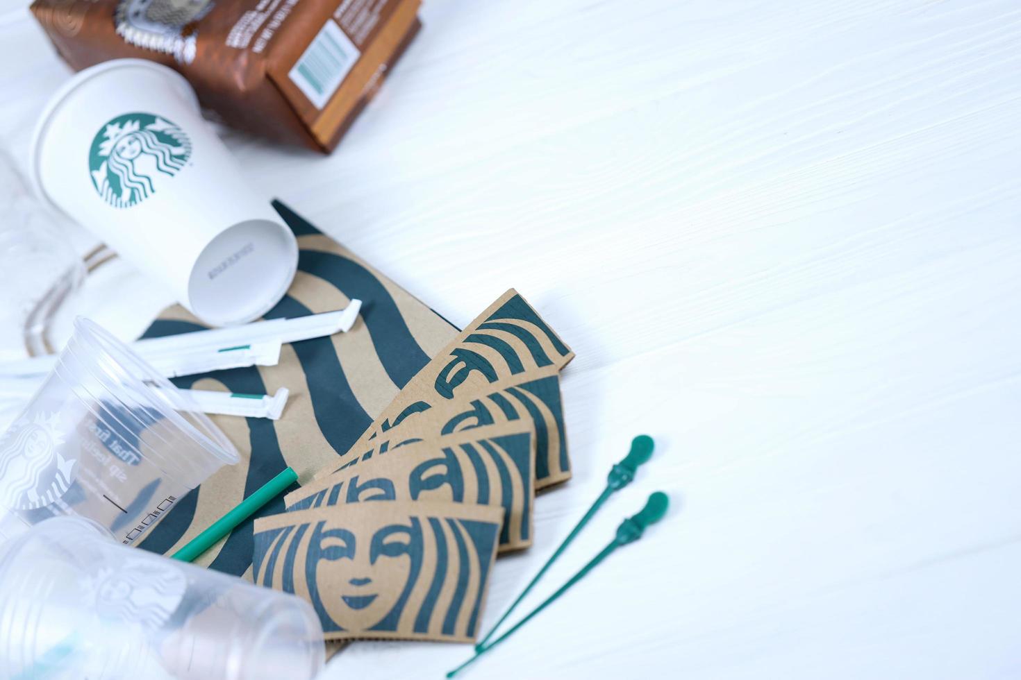 KHARKOV, UKRAINE - MARCH 15, 2021 Starbucks production on white wooden table. Starbucks Corporation is multinational chain of coffeehouses headquartered in Seattle, Washington photo