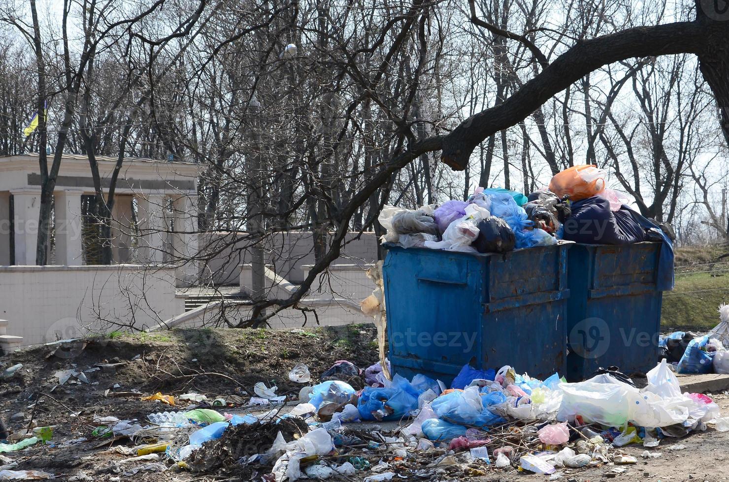 The garbage can is packed with garbage and waste. Untimely removal of garbage in populated areas photo