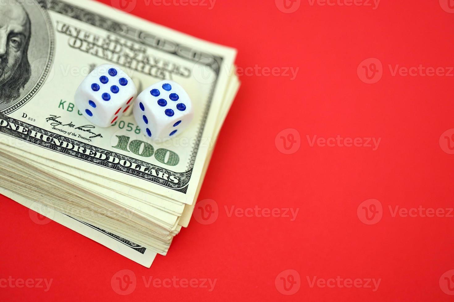 Money, finance and gambling concept. Close up on an American hundred US dollar banknotes and two white dice on top showing the numbers six photo