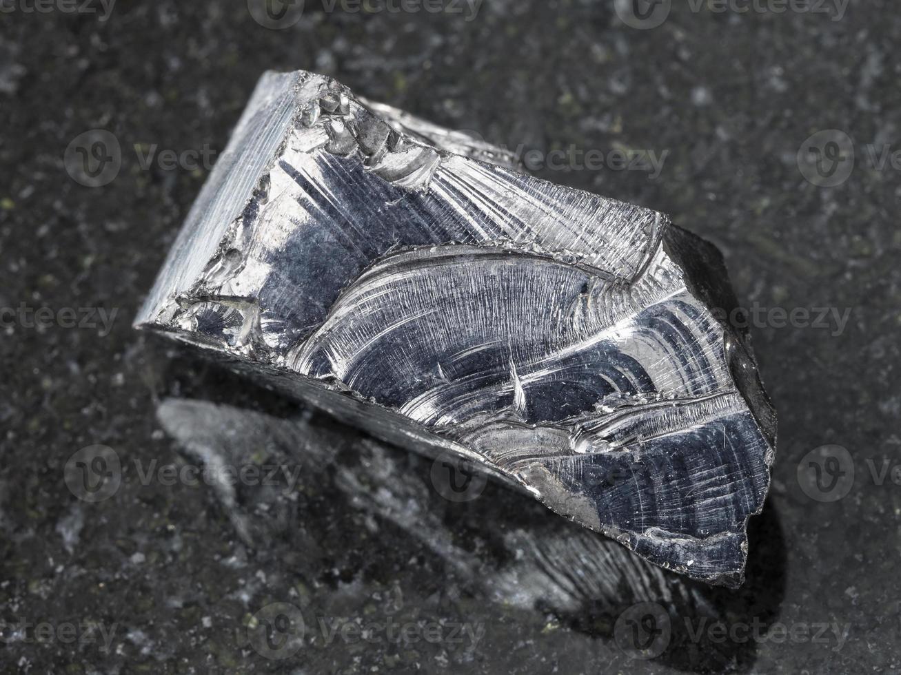 rough shungite stone on dark background photo