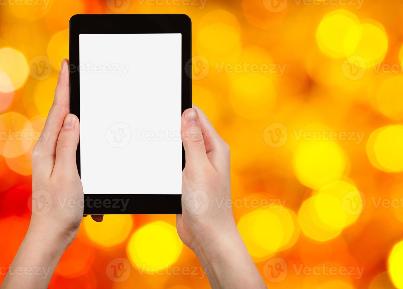 hand with tablet pc on blurred xmas background photo