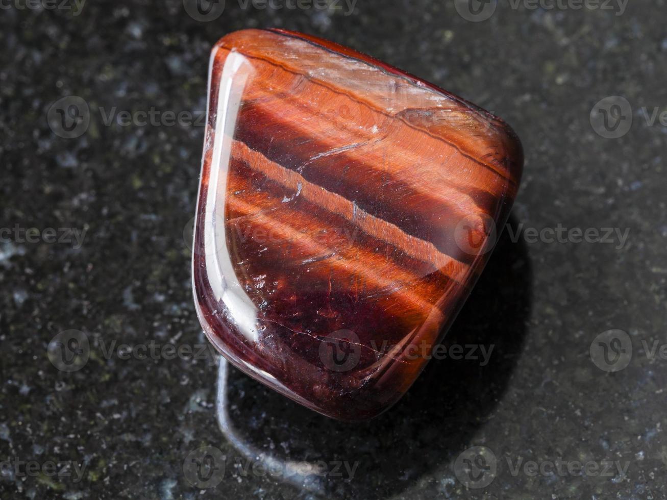 tumbled Bull’s Eye gemstone on dark background 13824595 Stock Photo at