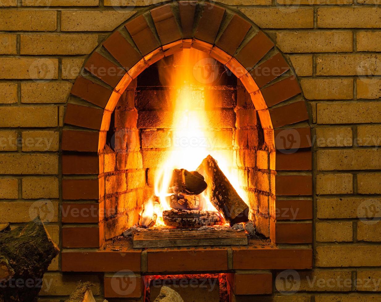 spurts of fire in brick fireplace photo