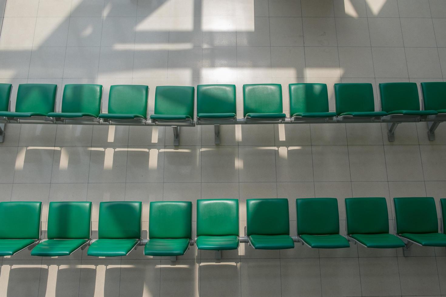 Green chairs are in line from top view. photo