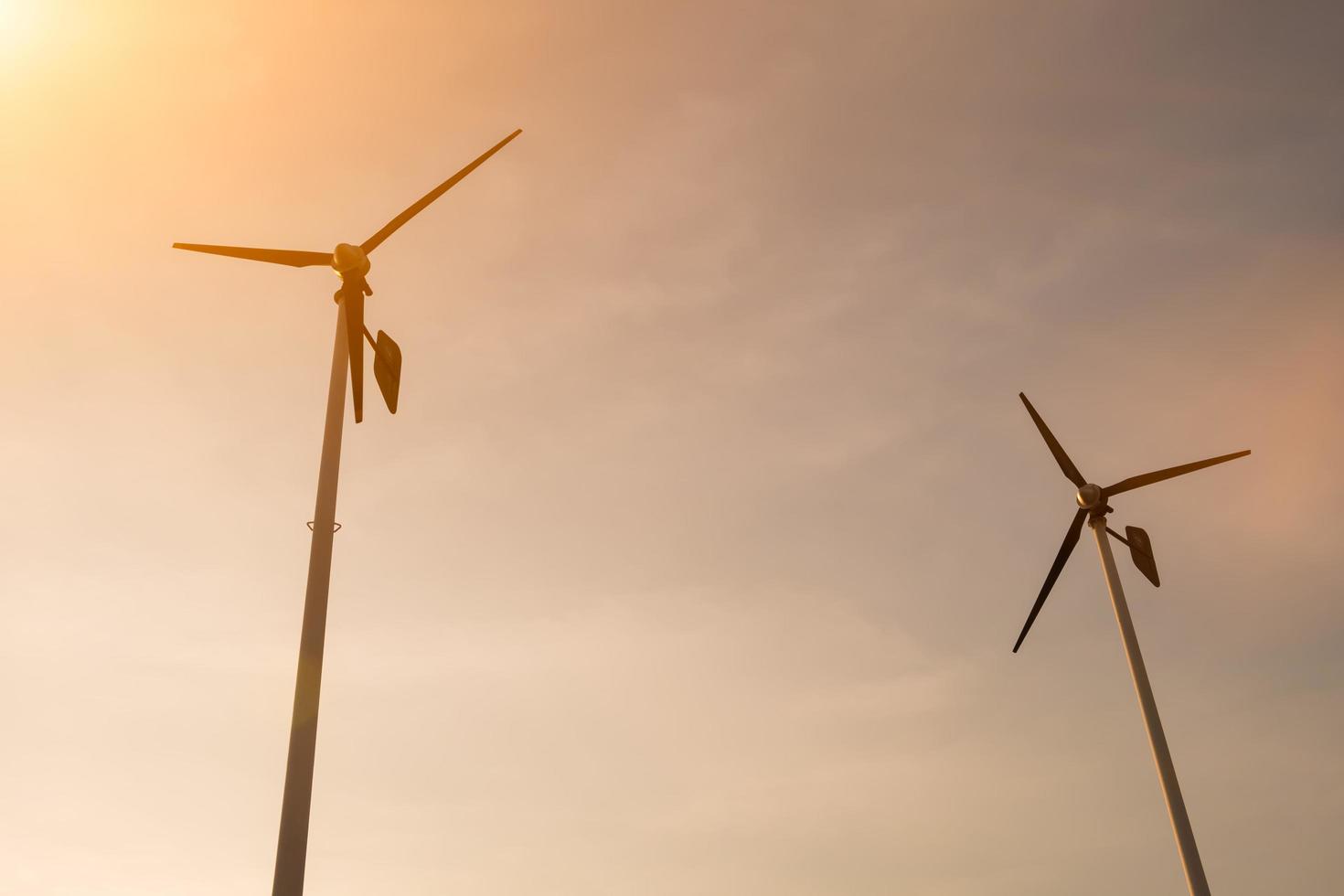 Wind turbines from ant view in sky background. photo