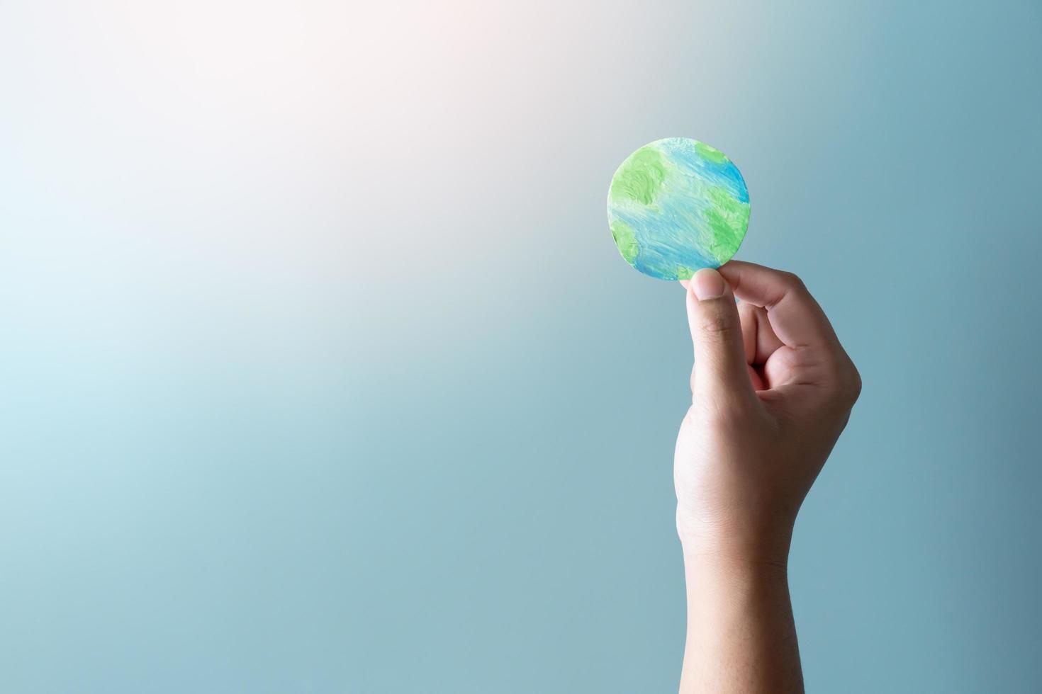 Hands holding earth. Concept of protecting the world from global warming. photo