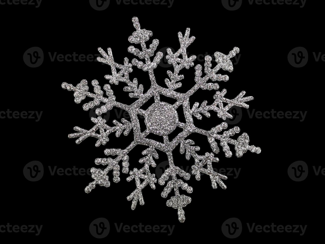 Shiny silver snowflake on black isolated background. Christmas, new year. Copy space photo