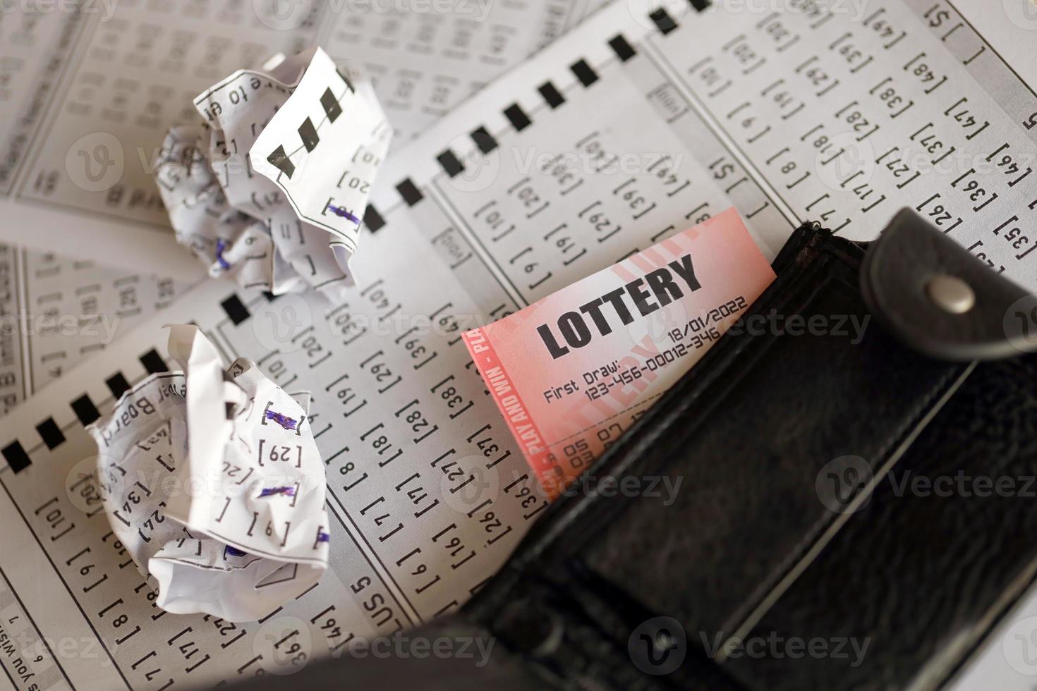 Crumpled lottery tickets and empty purse as symbol of losing the lottery game. Unlucky gambling results. Misfortune photo