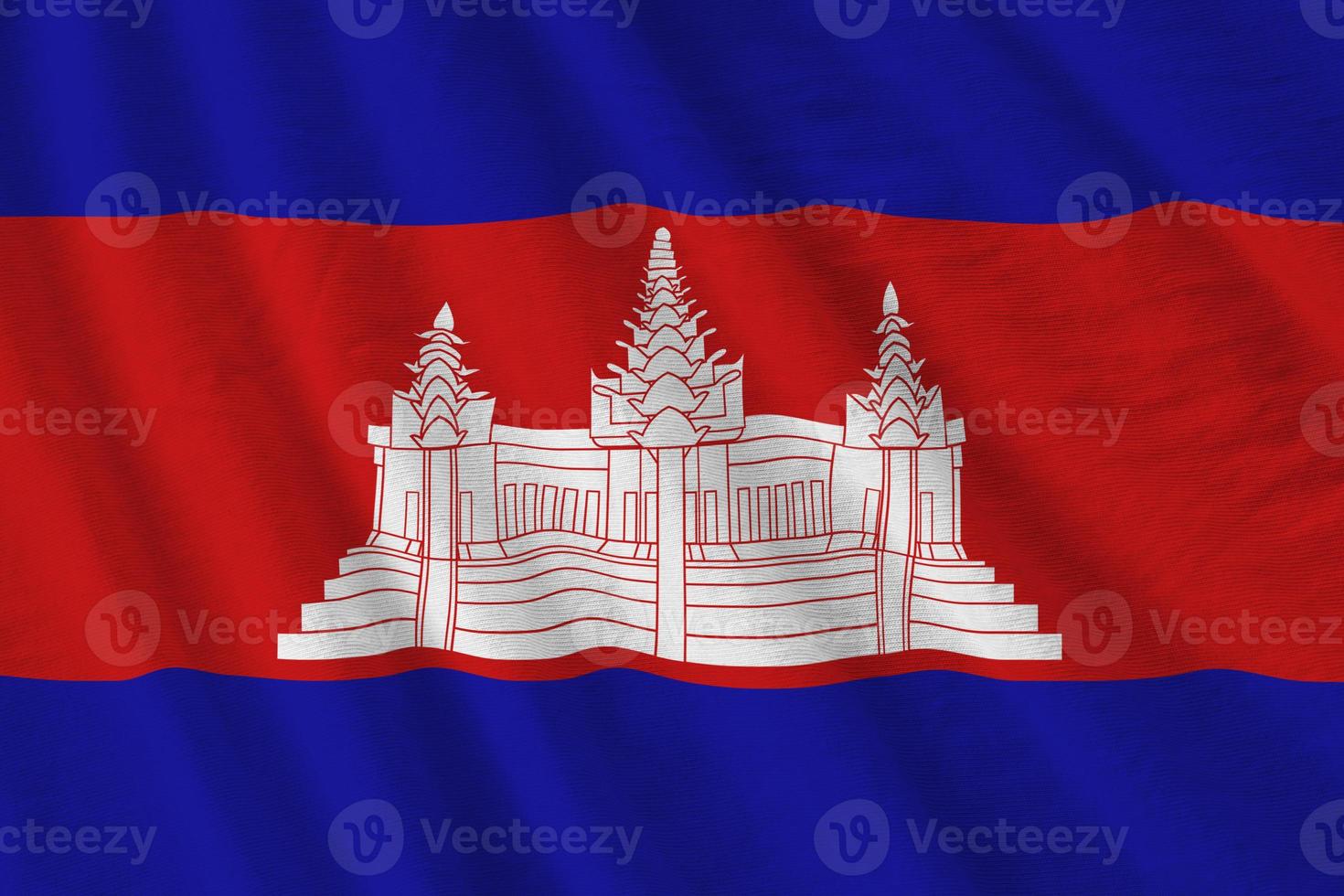 Cambodia flag with big folds waving close up under the studio light indoors. The official symbols and colors in banner photo