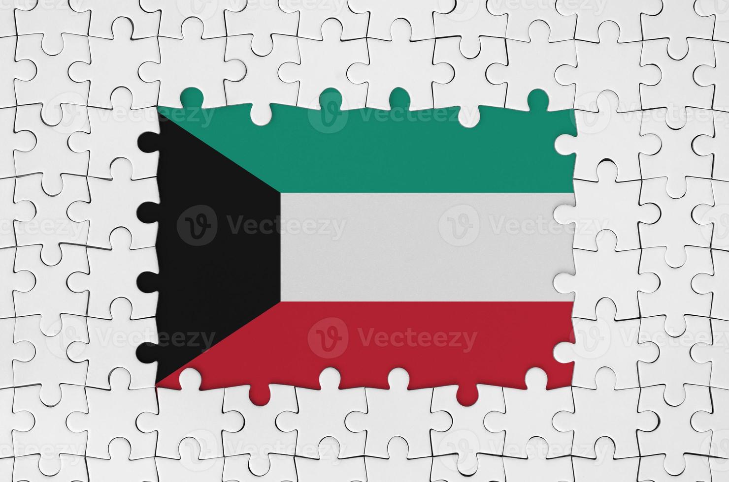 Kuwait flag in frame of white puzzle pieces with missing central part photo