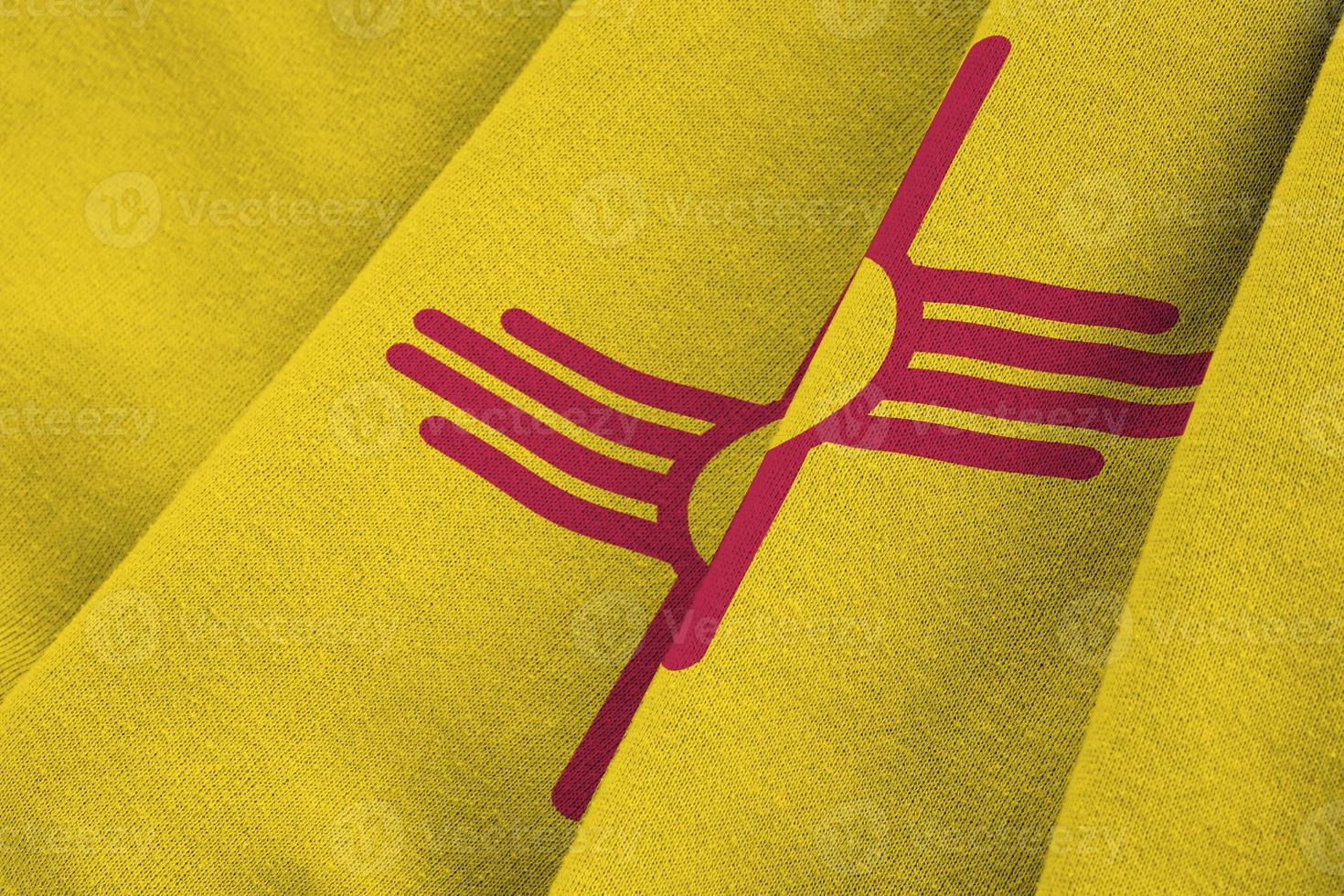 New Mexico US state flag with big folds waving close up under the studio light indoors. The official symbols and colors in banner photo