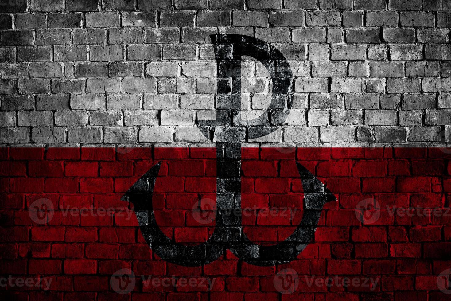 White and Red sign of Warsaw Rising  on brick wall in grunge style with colors of polish flag. Poland country industrial city graphic. World War Two. photo