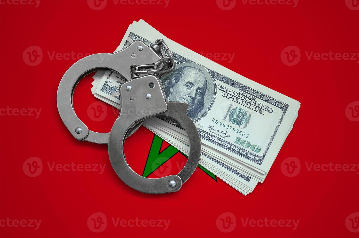 Morocco flag with handcuffs and a bundle of dollars. Currency corruption in the country. Financial crimes photo