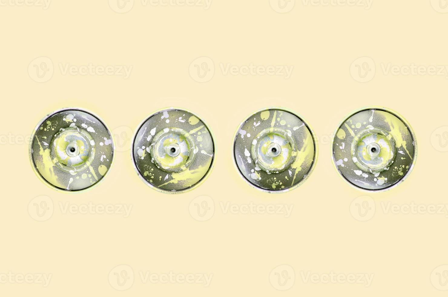 Many used spray cans for graffiti drawing lies on a pastel colored backgroung. Street art painting concept. Minimal flat lay pattern. Top view photo