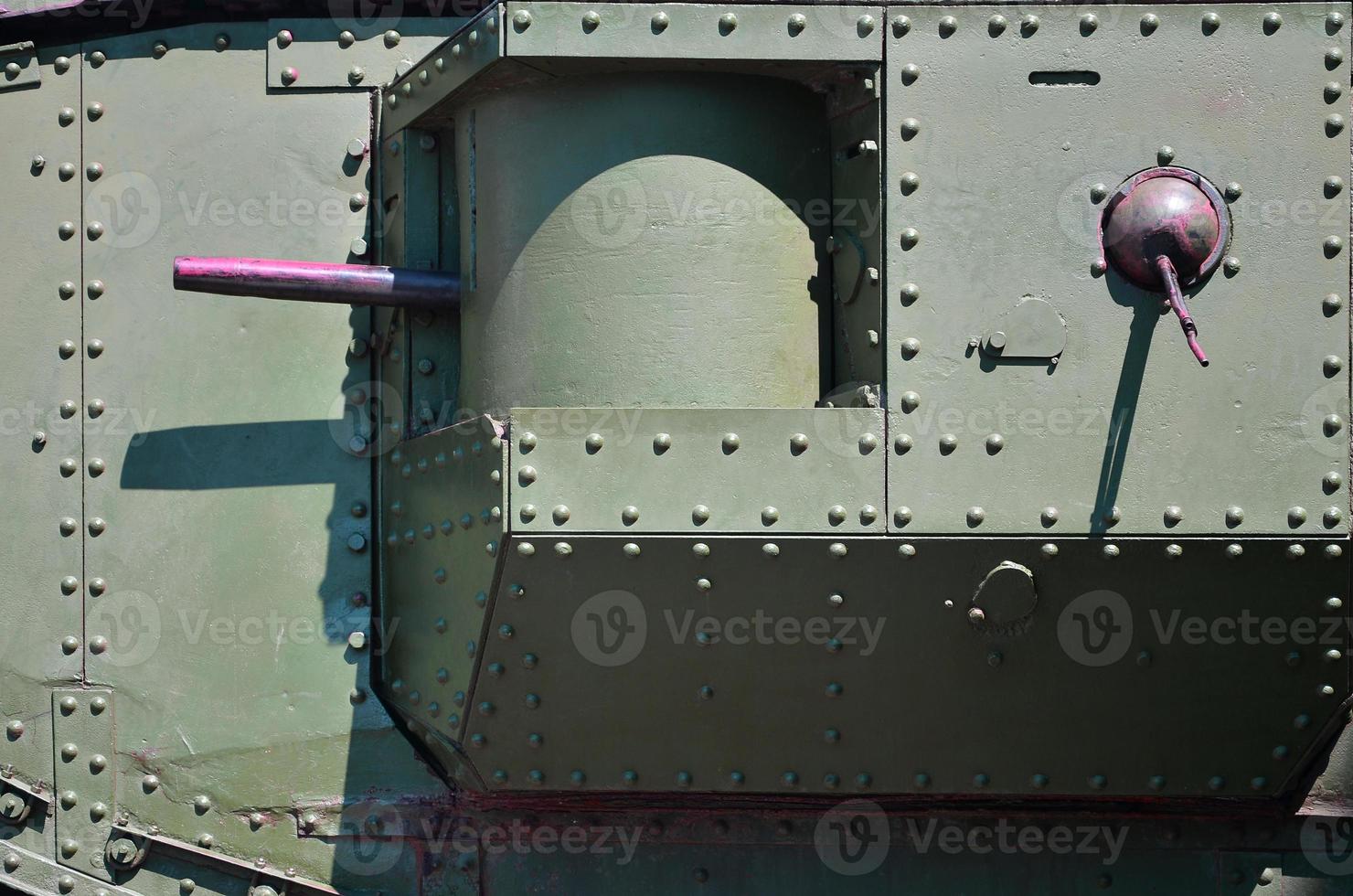 The texture of the wall of the tank, made of metal and reinforced with a multitude of bolts and rivets. Images of the covering of a combat vehicle from the Second World War with a guided machine gun photo