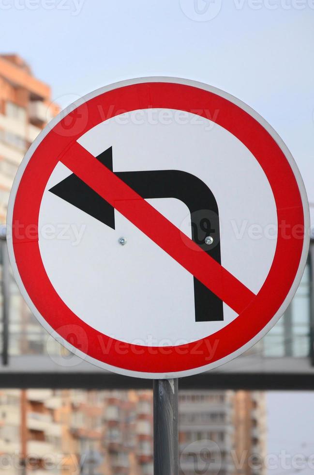 Turn left is prohibited. Traffic sign with crossed out arrow to the left photo