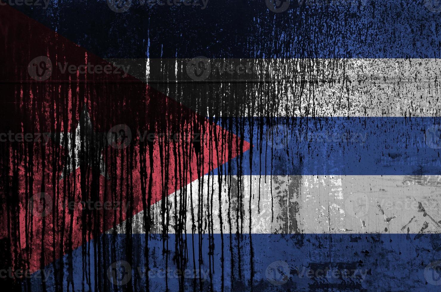 Cuba flag depicted in paint colors on old and dirty oil barrel wall closeup. Textured banner on rough background photo